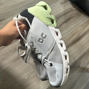 On Running White and Green Athletic Shoes